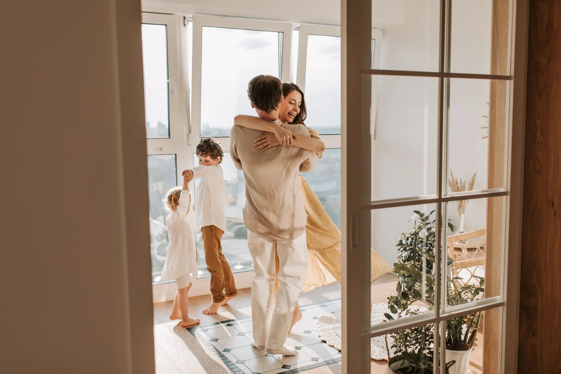 Family embracing inside a bright contemporary home